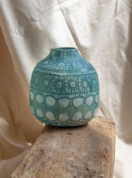 Blue handmade ceramic vase on white textured table cloth. Home decor, Copy space, Selective focus.