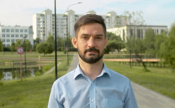 Portrait of a man in blue shirt on the city background