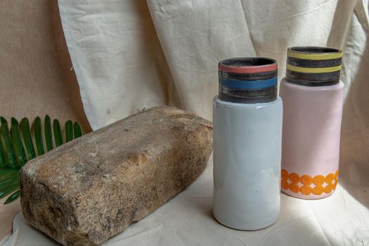 Two Pink and White handmade ceramic vases on white textured table cloth. Home decor, Copy space, Selective focus.