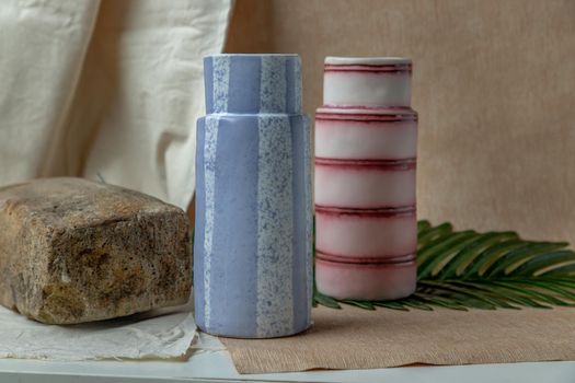 Two handmade ceramic vases on white textured table cloth. Home decor, Copy space, Selective focus.