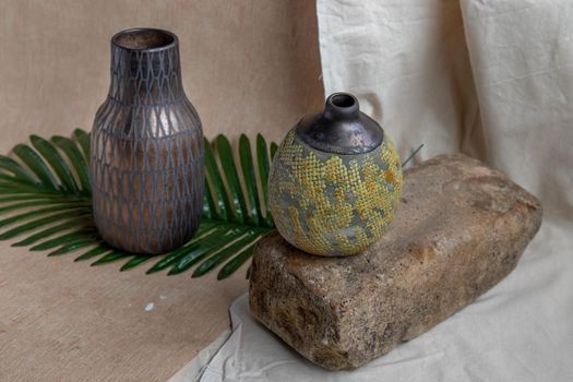 Two handmade ceramic vases on white textured table cloth. Home decor, Copy space, Selective focus.