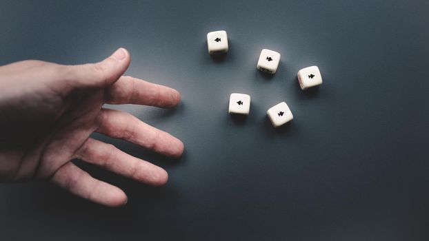 Throwing the dice on a dark grey background. Five aces.