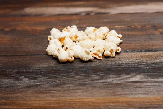popcorn on a wooden table snack classic delicacy. High quality photo