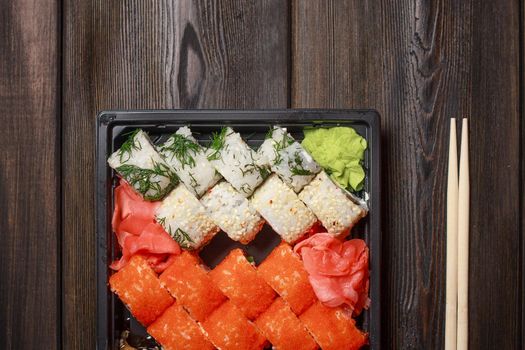 set of sushi rolls wooden sticks on the table top view. High quality photo