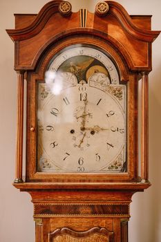 Ancient floor mechanical clock. The watch closet is close-up.