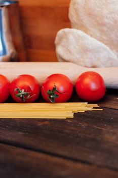 italian pasta on a wooden table cherry tomatoes cooking lunch. High quality photo