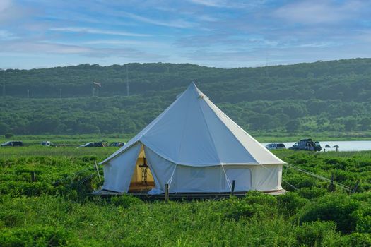 White tent on the background of the natural landscape. Travel and tourism.