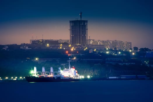 Urban landscape with a view of the night city. Vladivostok, Russia