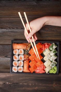 sushi chopsticks rolls snack delicacy japanese cuisine. High quality photo