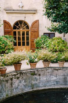 Ancient fountain in the center of the courtyard of a villa-winery in Italy, Tuscany.