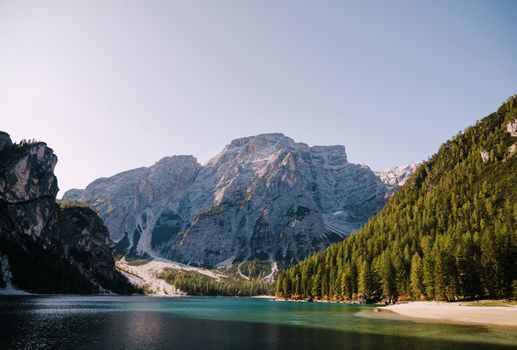 Rocky Mountains with green forests on Lago di Braies. Braies lake in the Dolomites in South Tyrol, Italy, Briesmunicipality Municipality, in the Valley of Prague.