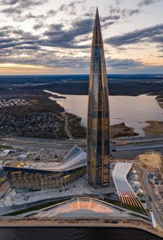 Russia, St.Petersburg, 06 May 2020: Aerial panoramic image of skyscraper Lakhta center at sunset, night illumination is on, It is the highest skyscraper in Europe, Completion of construction, dusk