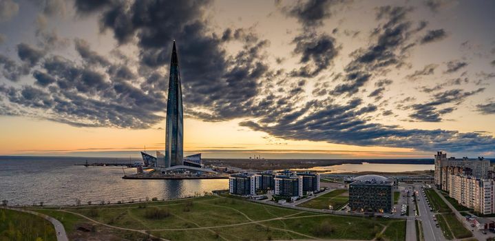 Russia, St.Petersburg, 06 May 2020: Aerial panoramic image of skyscraper Lakhta center at sunset, night illumination is on, It is the highest skyscraper in Europe, Completion of construction, dusk