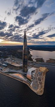 Russia, St.Petersburg, 06 May 2020: Aerial panoramic image of skyscraper Lakhta center at sunset, night illumination is on, It is the highest skyscraper in Europe, Completion of construction, dusk