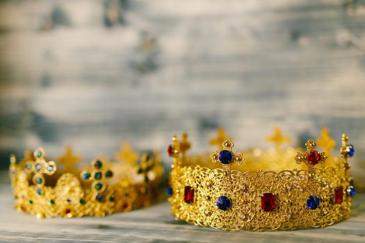 Two golden crowns encrusted with precious stones for a religious wedding in an Orthodox church