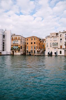 Old houses on Grand Canal, Venice, Italy. Vintage hotels and residential buildings in Venice center. Historical architecture of Venice on water in summer. Venetian street with ancient facades.
