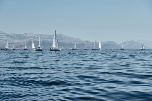 Beautiful sea landscape with sailboats, the race of sailboats on the horizon, a regatta, a Intense competition, island with windmills are on background