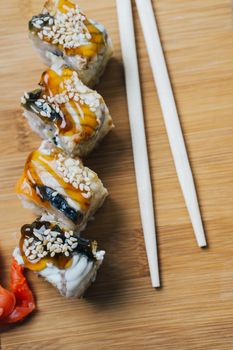 japanese cuisine sushi sauce chopsticks ginger wood board. High quality photo