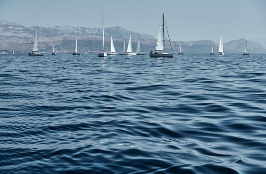 Beautiful sea landscape with sailboats, the race of sailboats on the horizon, a regatta, a Intense competition, island with windmills are on background