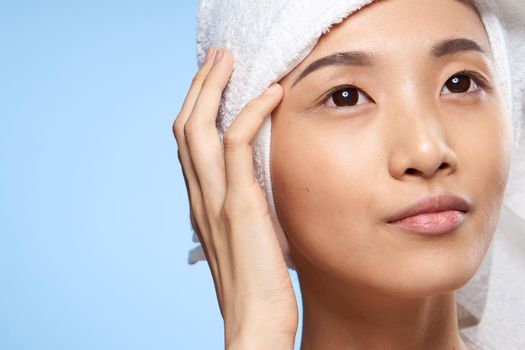 woman with bare shoulders close-up towel on head clean skin rejuvenation. High quality photo
