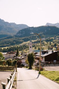 White houses and rocky mountains with dense green forest in the Dolomites in South Tyrol, Italy. Bries Municipality, in the Valley of Prague.