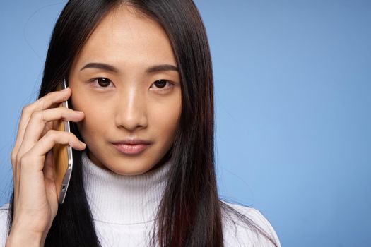 woman of asian appearance talking on the phone technology internet. High quality photo