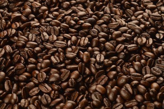 A closeup macro shot of freshly roasted coffee beans to create a full frame background.