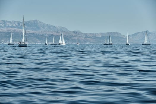 Beautiful sea landscape with sailboats, the race of sailboats on the horizon, a regatta, a Intense competition, island with windmills are on background