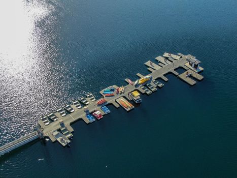 Aerial view of Miramar Lake small pier with pedal boat, small motor boat. Lake with popular activities including boating, fishing, San Diego, California, USA