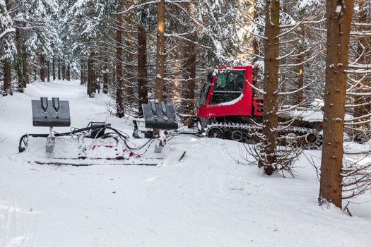 snowmobile to adjust the tracks for cross-country skiers in the winter forest.