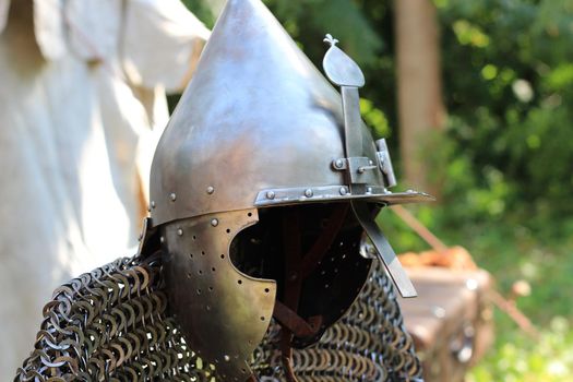 Knight's armor: a helmet and a close-up of the chain mail on a blurry background.