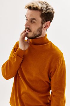 man in a sweater looking to the side fashionable hairstyle mens clothing. High quality photo