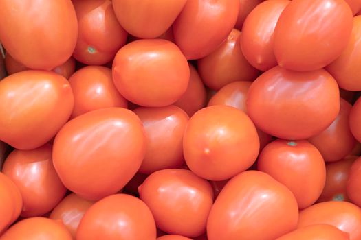 ripe red tomatoes close up on the shelves of supermarket stores. High quality photo