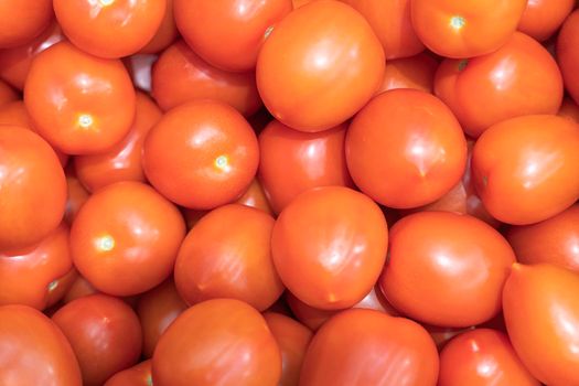 ripe red tomatoes close up on the shelves of supermarket stores. High quality photo