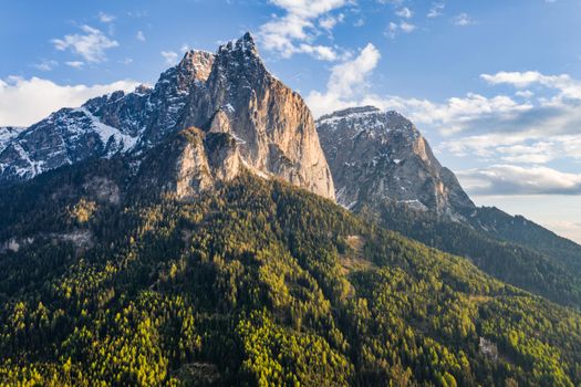 Aerial view of improbable peak of mountains, Italian Alps, green slopes of the mountains, Bolzano, Dolomites