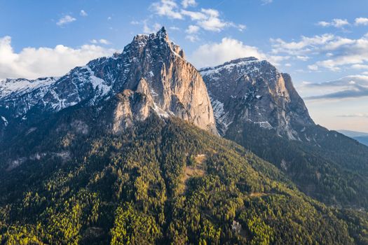 Aerial view of improbable peak of mountains, Italian Alps, green slopes of the mountains, Bolzano, Dolomites