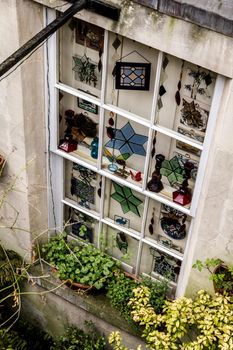 Basement white window with several glass decorations