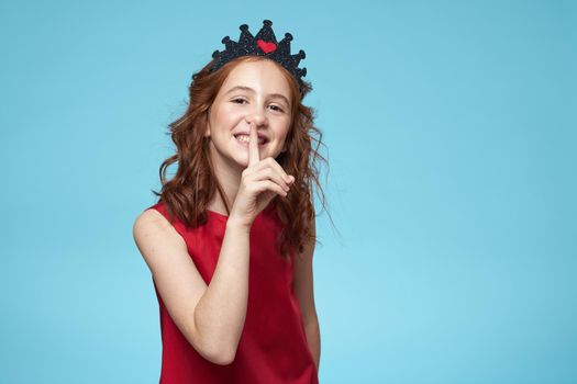 Girl in red dress with curly hair fun lifestyle blue background. High quality photo