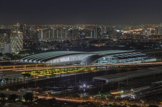 Bangkok, thailand - Aug 28, 2020 : Aerial view of Bang Sue central station with skyscrapers background at night. Selective focus.