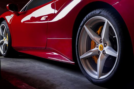 Bangkok, Thailand - 06 Jan 2021 : Close-up of Wheel of Red Ferrari Sports Car.  Ferrari is Italian sports car. Selective focus.