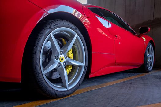 Bangkok, Thailand - 06 Jan 2021 : Close-up of Wheel of Red Ferrari Sports Car.  Ferrari is Italian sports car. Selective focus.