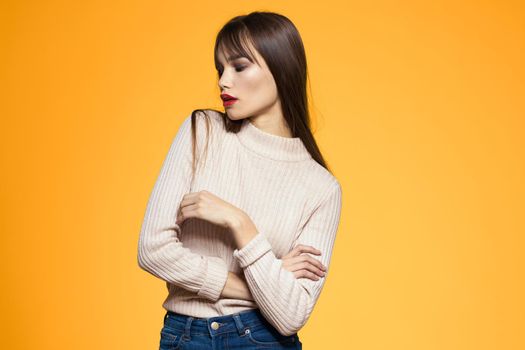 Cute brunette red lips fashionable clothes studio yellow background. High quality photo
