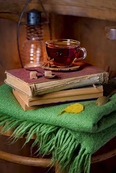 tea cup, green plaid, books on a chair. Home interior vintage dec up withor