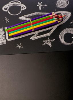 School supplies on blackboard background.