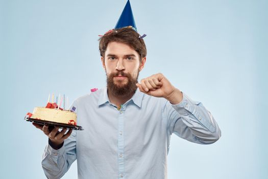 Bearded man with cap on his head cake holiday gift emotions. High quality photo