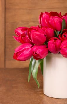 Fresh pink tulips on the wooden background