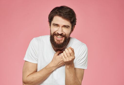 Portrait of a cheerful man on a pink background emotions cropped view. High quality photo