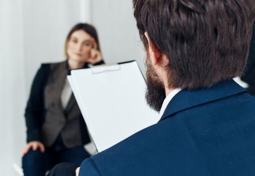 Business man communicates with a woman in a suit, staff vacancies resume. High quality photo