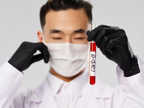 male doctor in black gloves tests and diagnostics blood biochemistry research. High quality photo