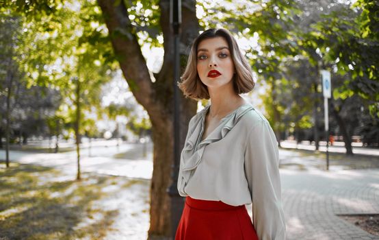 beautiful woman resting in the park near green trees in nature. High quality photo